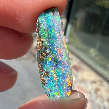 A loose, vivid boulder opal stone from Quilpie, Australia.