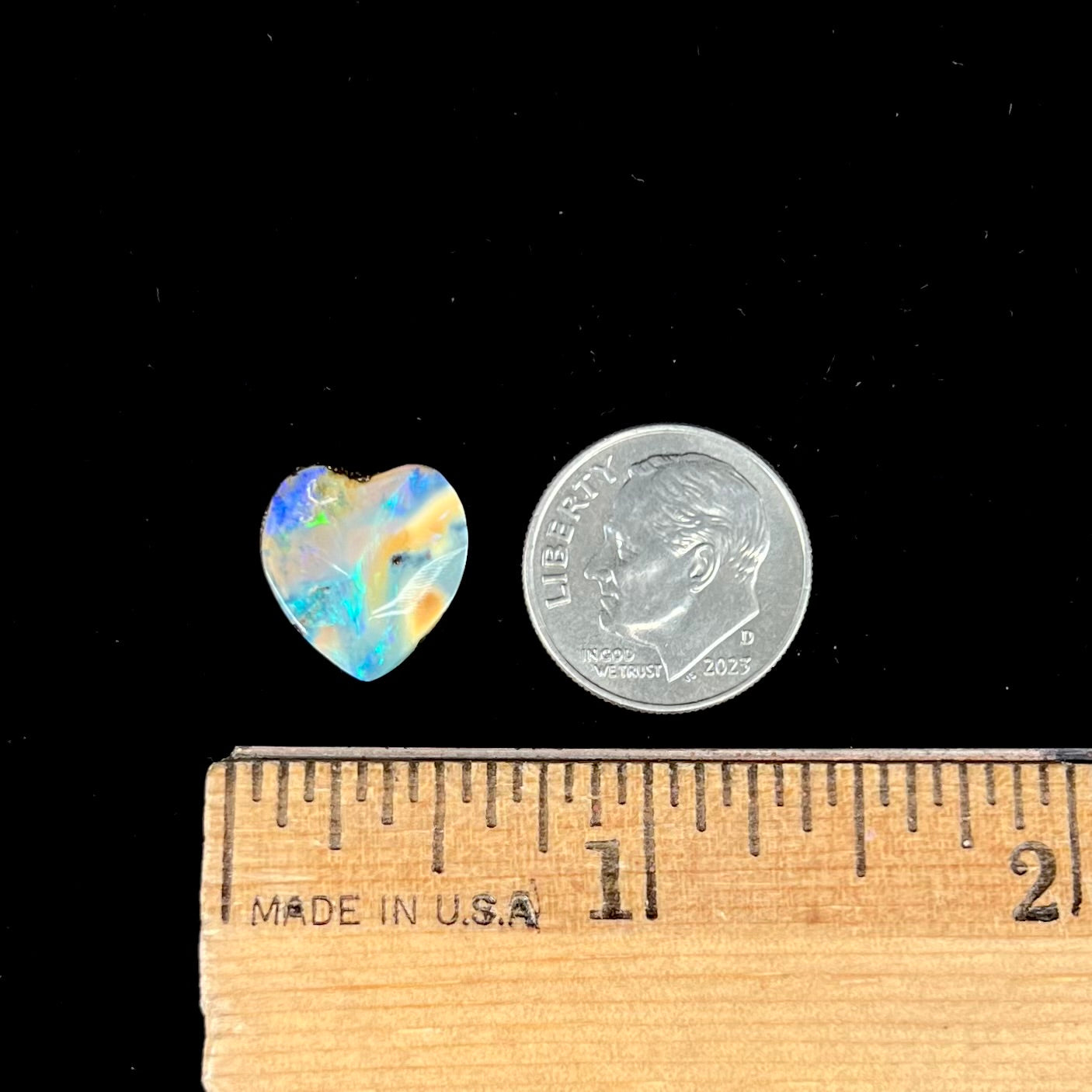 A loose, 5.90 carat heart shaped boulder opal stone from Quilpie, Australia.  The opal has blue flashes.