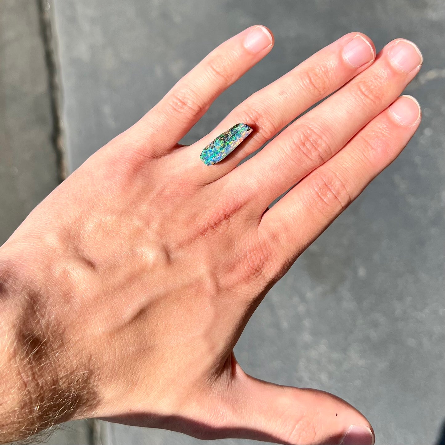 A loose, vivid boulder opal stone from Quilpie, Australia.