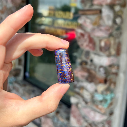 A loose boulder opal stone with purple veins from Koroit, Australia.