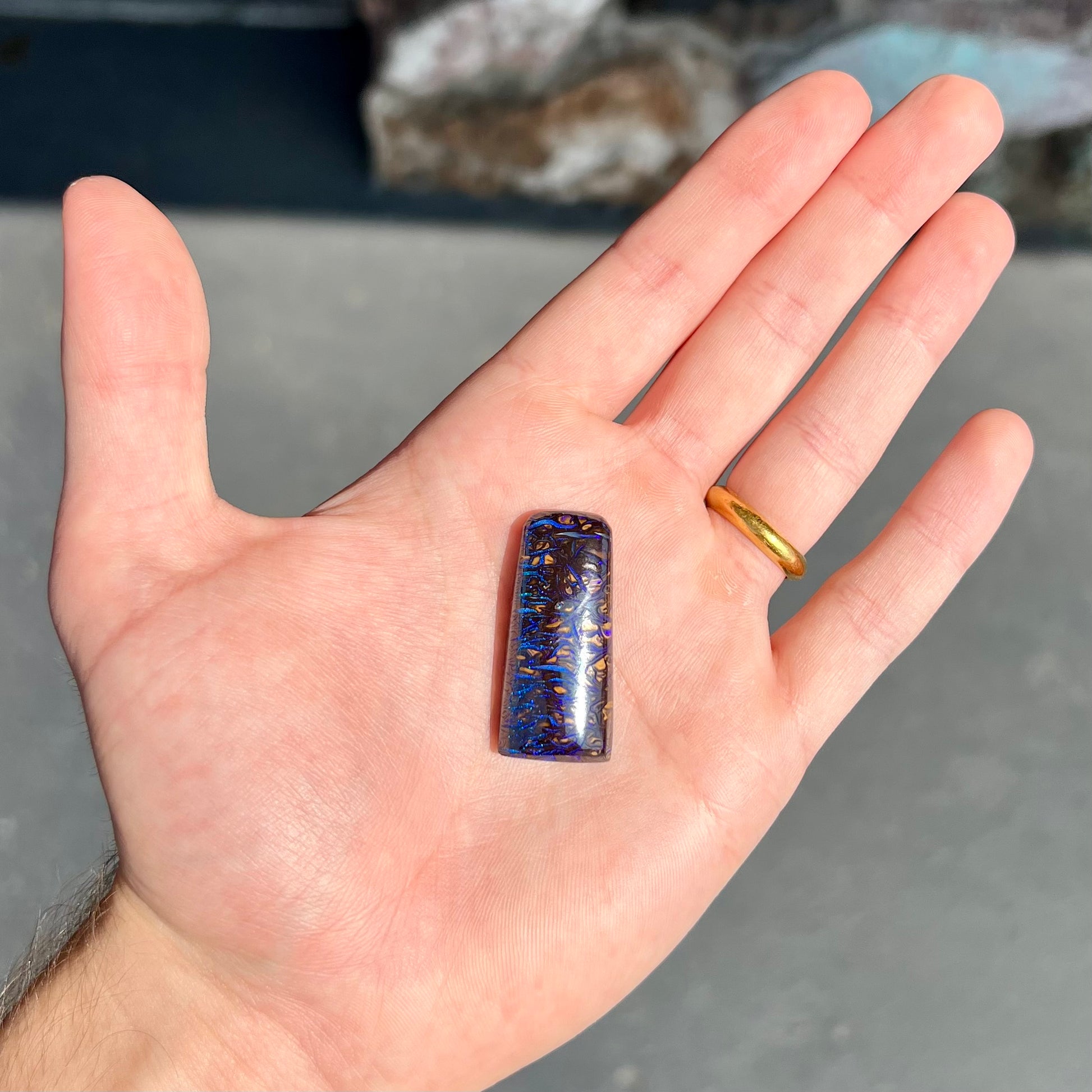 A loose boulder opal stone with purple veins from Koroit, Australia.