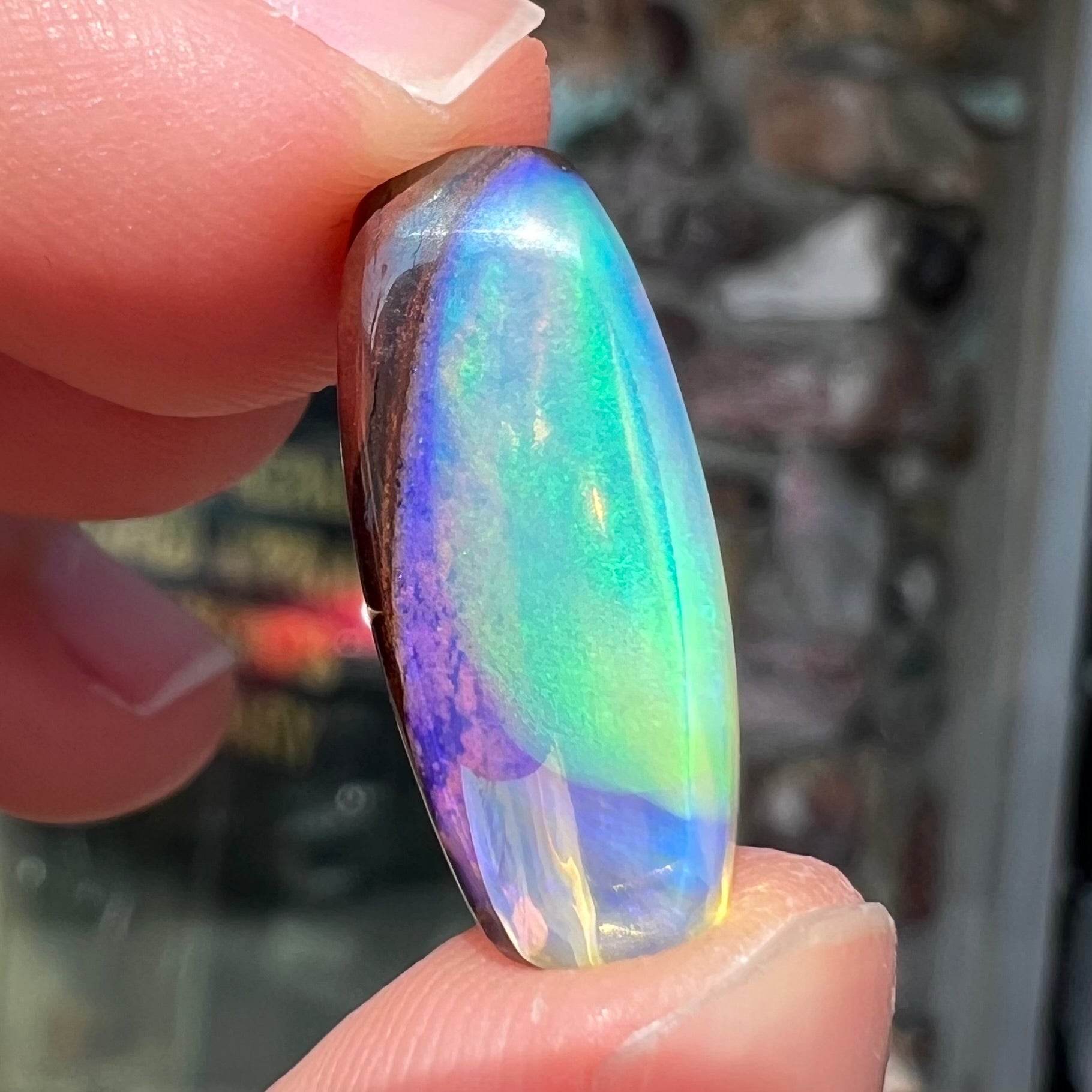 A 6.32ct Brazilian opal stone.  The opal has a green and blue rain pattern.