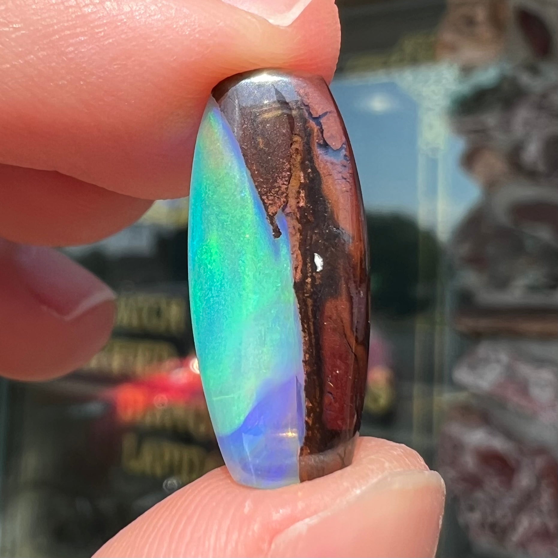 A 6.32ct Brazilian opal stone.  The opal has a green and blue rain pattern.