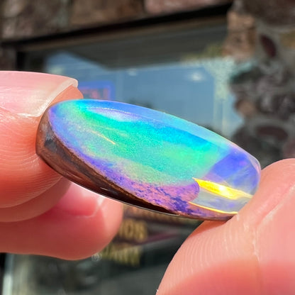 A 6.32ct Brazilian opal stone.  The opal has a green and blue rain pattern.