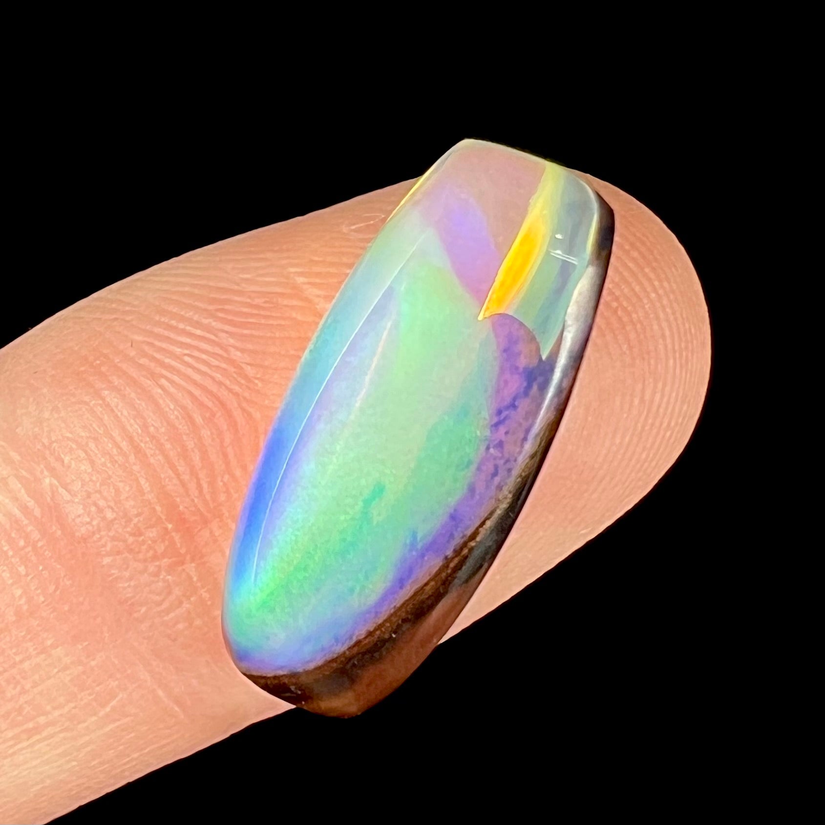 A 6.32ct Brazilian opal stone.  The opal has a green and blue rain pattern.