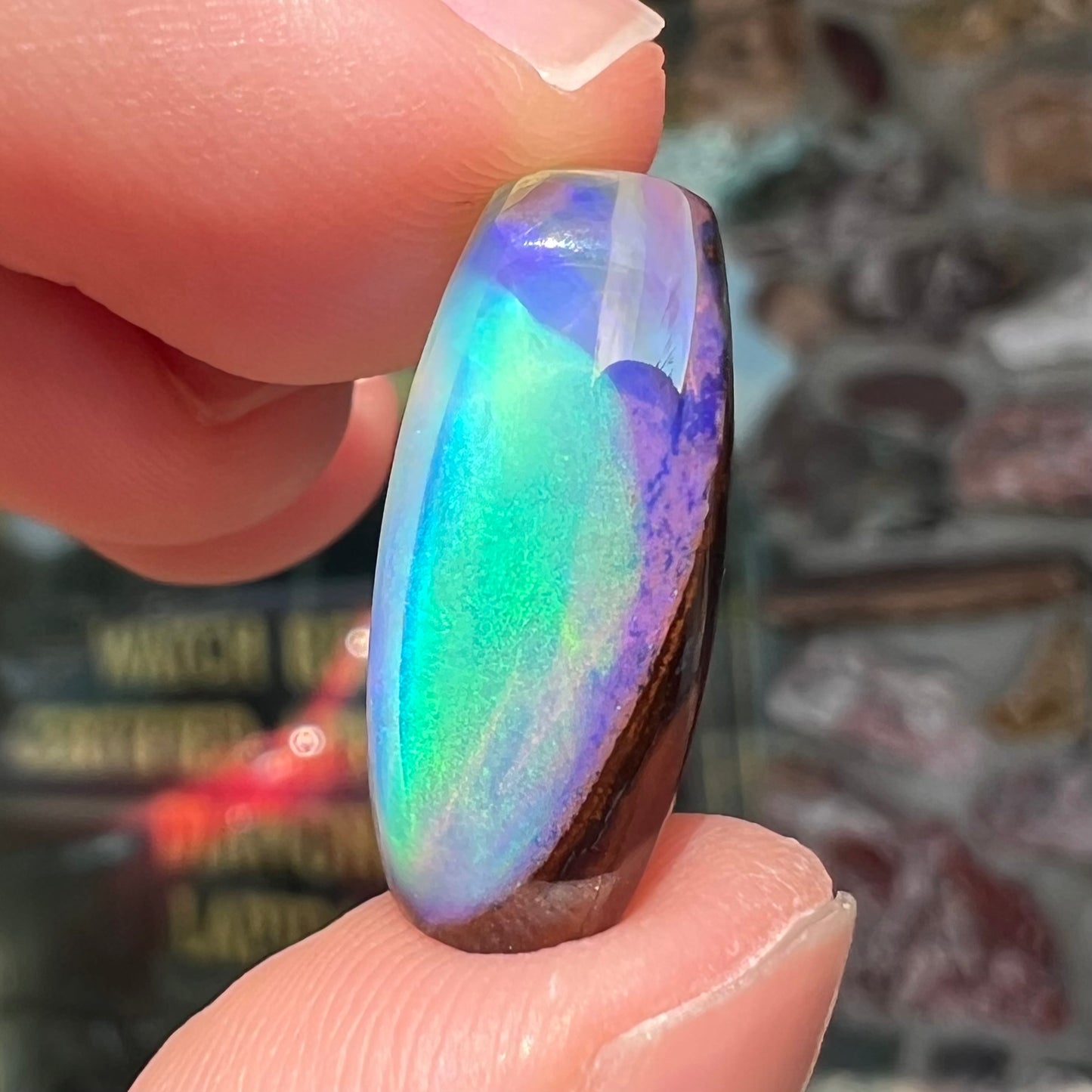 A 6.32ct Brazilian opal stone.  The opal has a green and blue rain pattern.