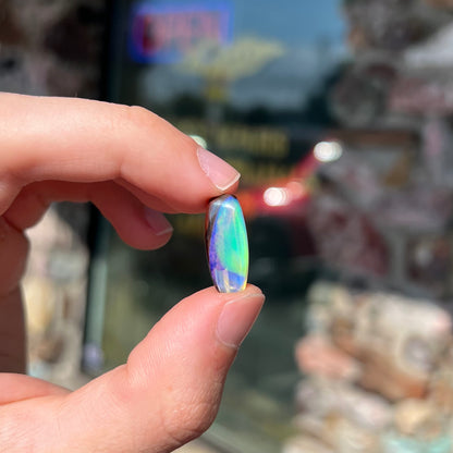 A 6.32ct Brazilian opal stone.  The opal has a green and blue rain pattern.