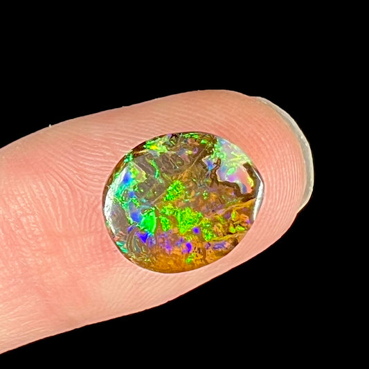 A bright green boulder opal stone from Koroit, Australia.