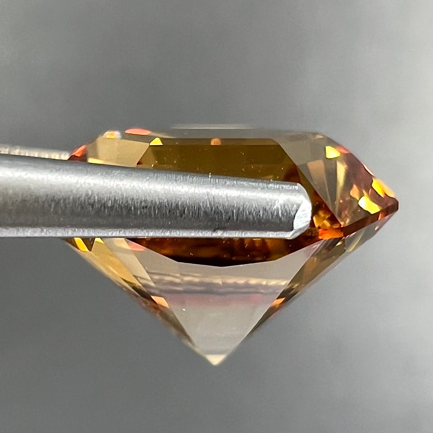 A loose, faceted hexagon cut citrine gem.  The stone is golden yellow color.