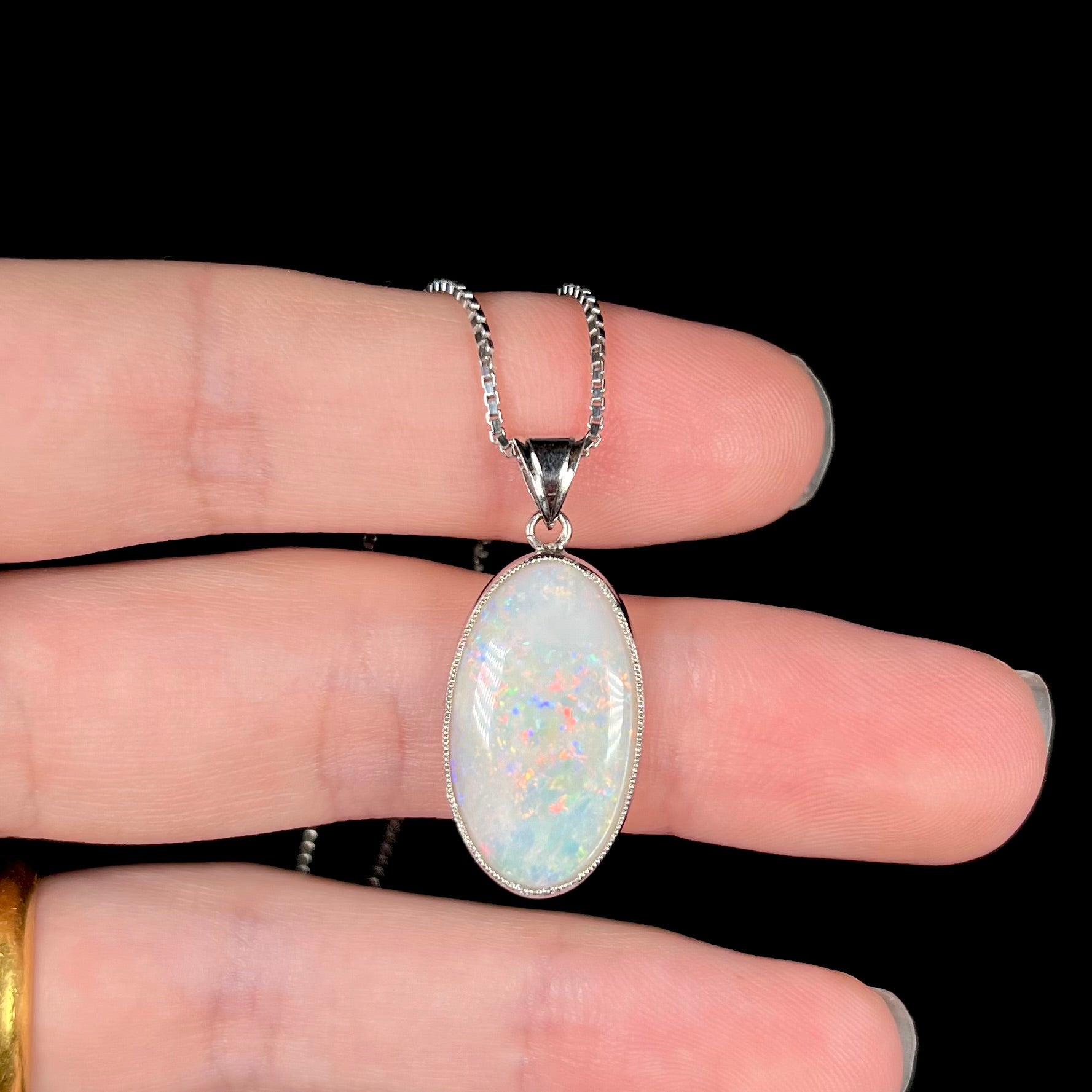 A platinum pendant mounted with an oval cut Australian white opal.