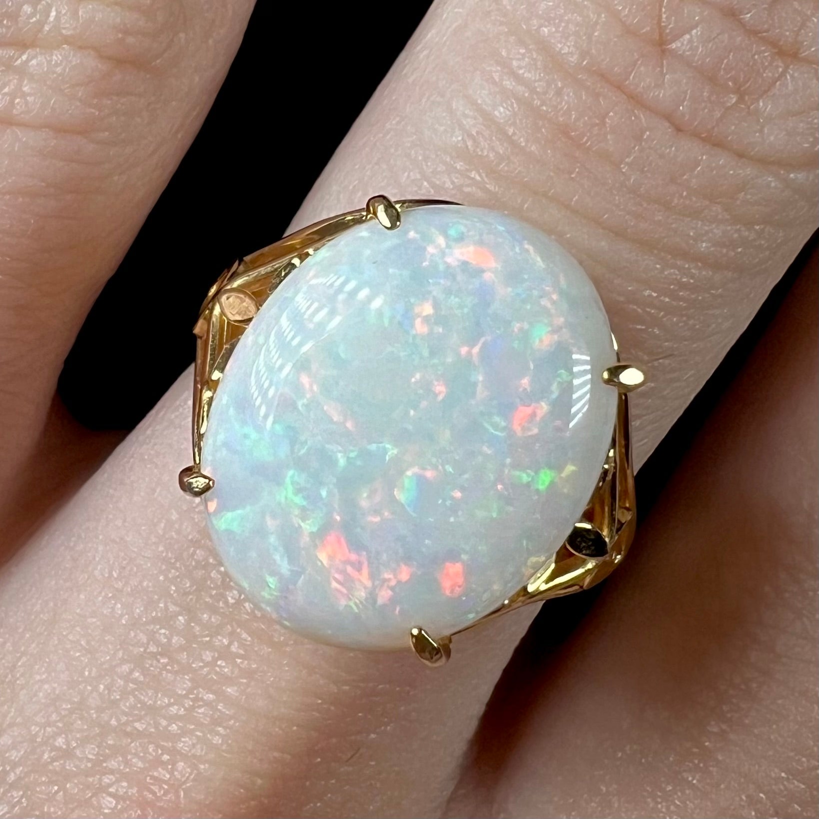 A yellow gold solitaire cocktail ring mounted with a natural white opal from Coober Pedy, Australia.