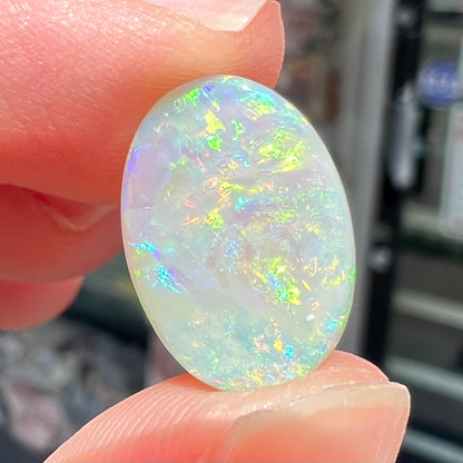 A double-sided opal stone from Coober Pedy, Australia.  The opal plays green, blue, and orange colors from the front and the back.