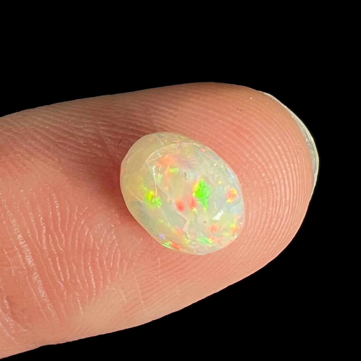 An oval cabochon cut opal from Australia.  The opal has crazing.