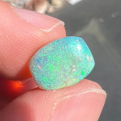 A 2.40ct barrel shaped Lightning Ridge semi-crystal opal.  The stone has blue and green colors.