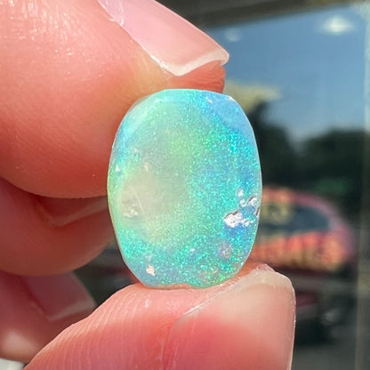 A 2.40ct barrel shaped Lightning Ridge semi-crystal opal.  The stone has blue and green colors.