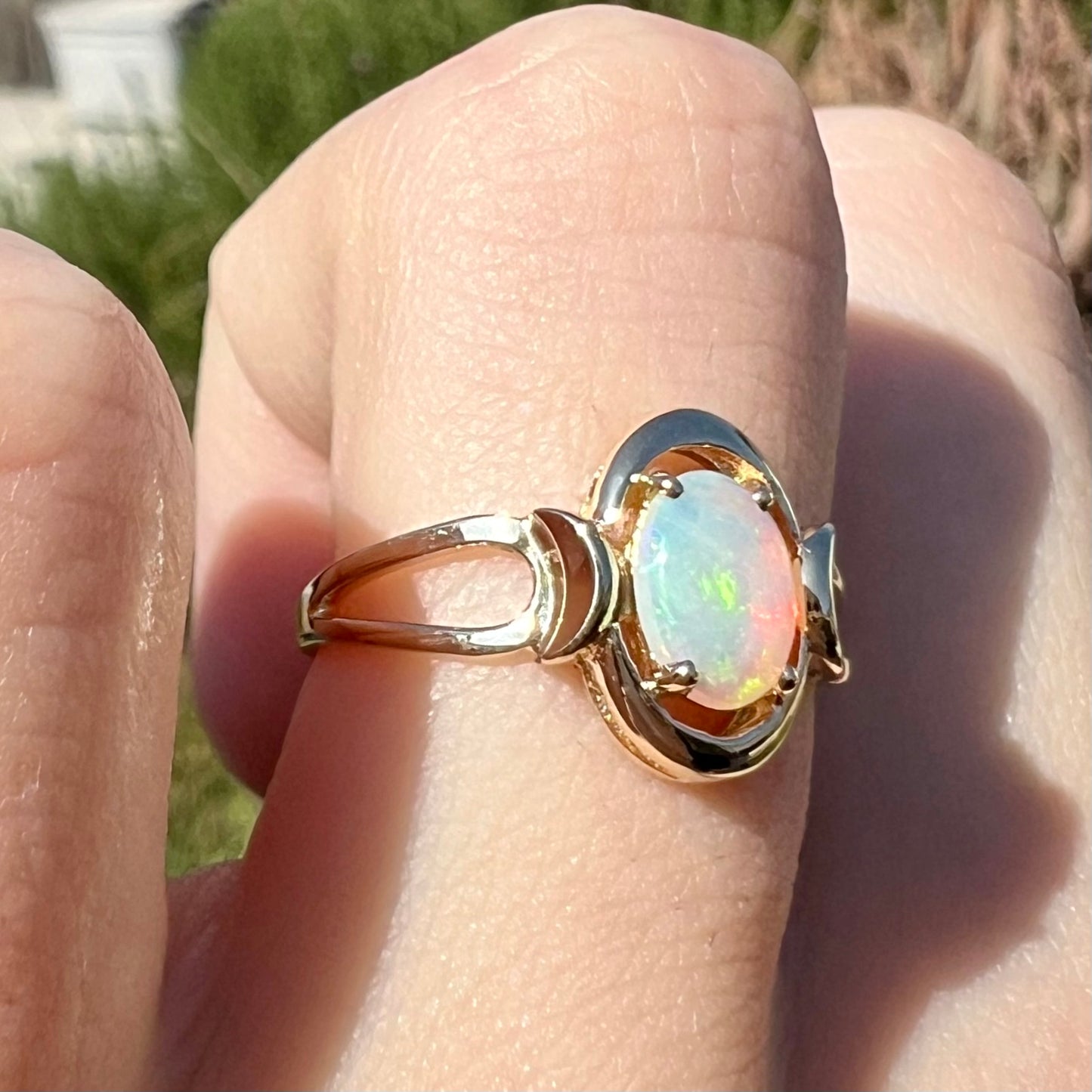 A 14 karat yellow gold open-shank design Australian crystal opal ring.