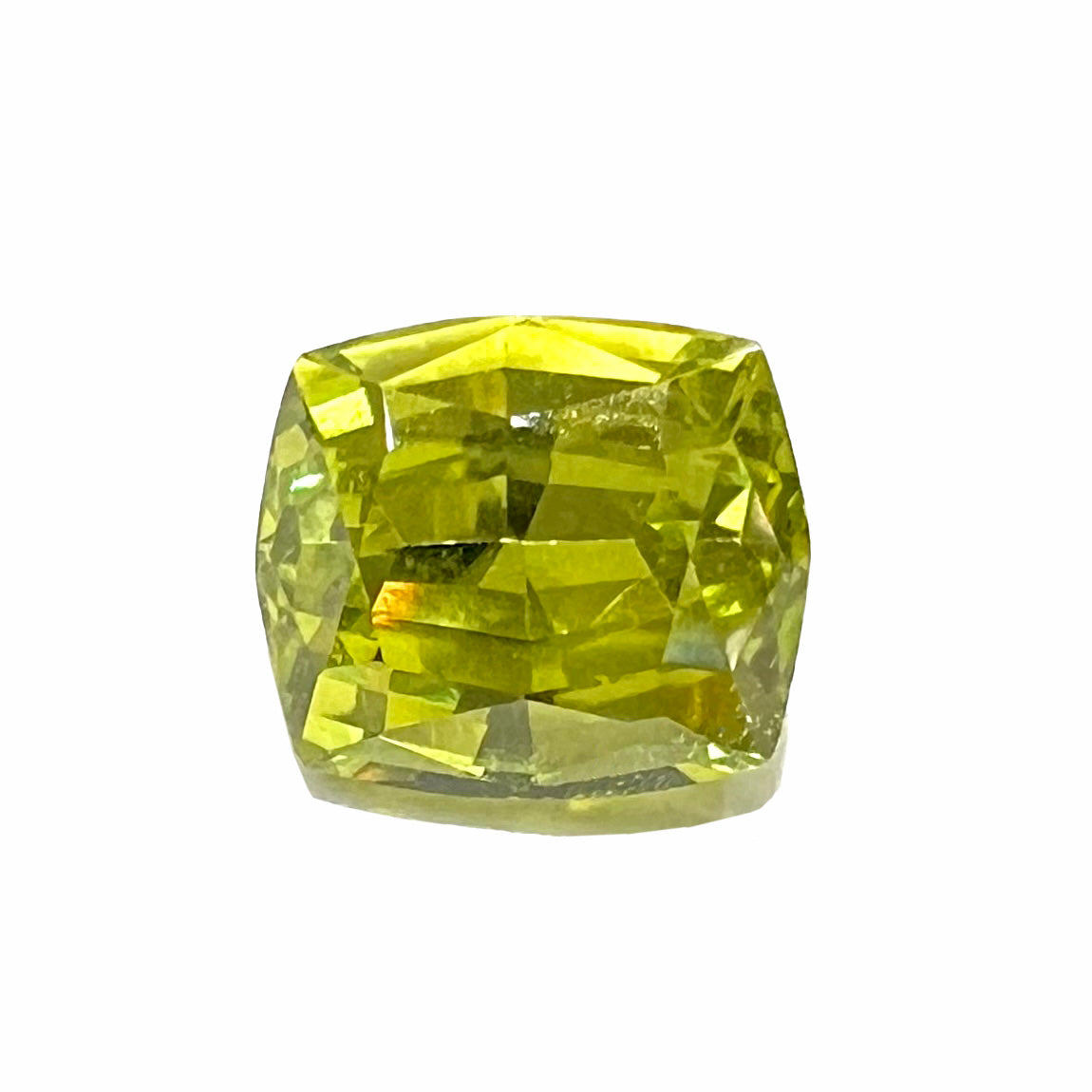 A loose, modified cushion cut greenish yellow chrysoberyl gemstone.