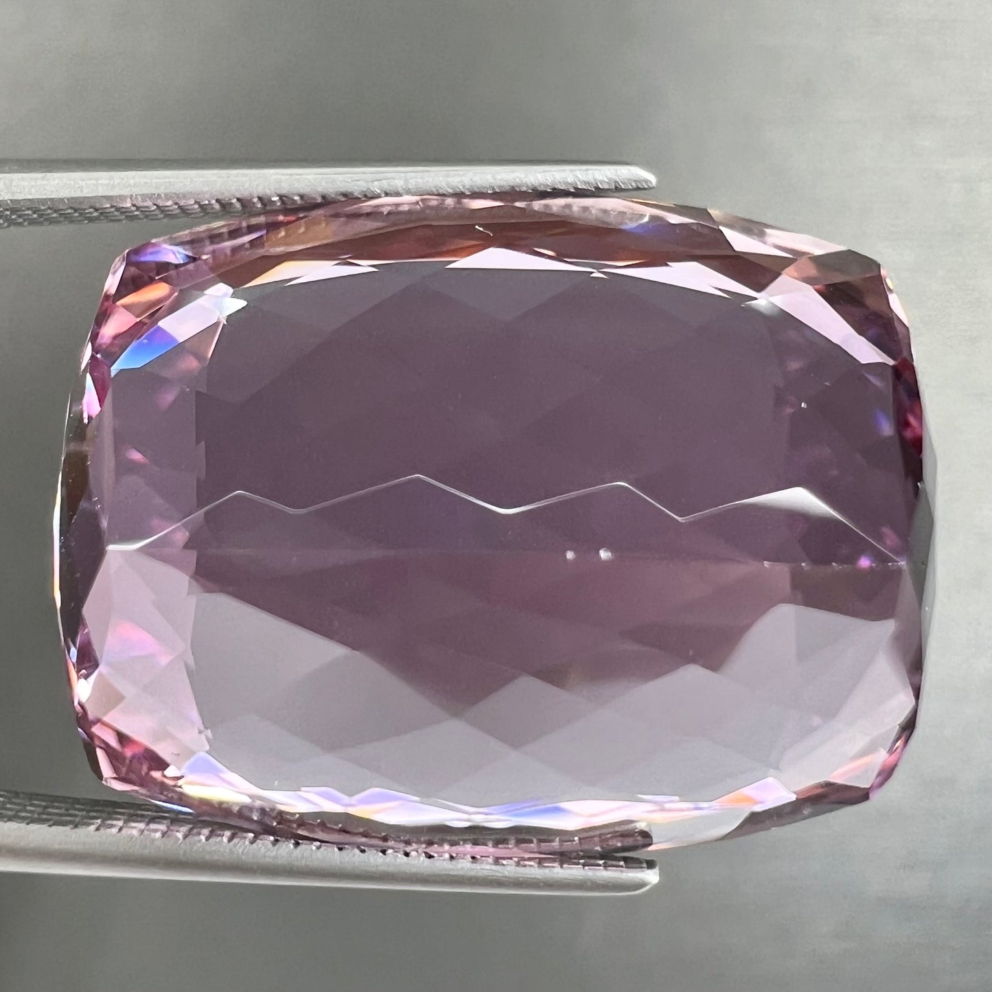 A modified cushion cut Afghanistan kunzite gemstone.  The stone is a purplish pink color and weighs 49.30 carats.