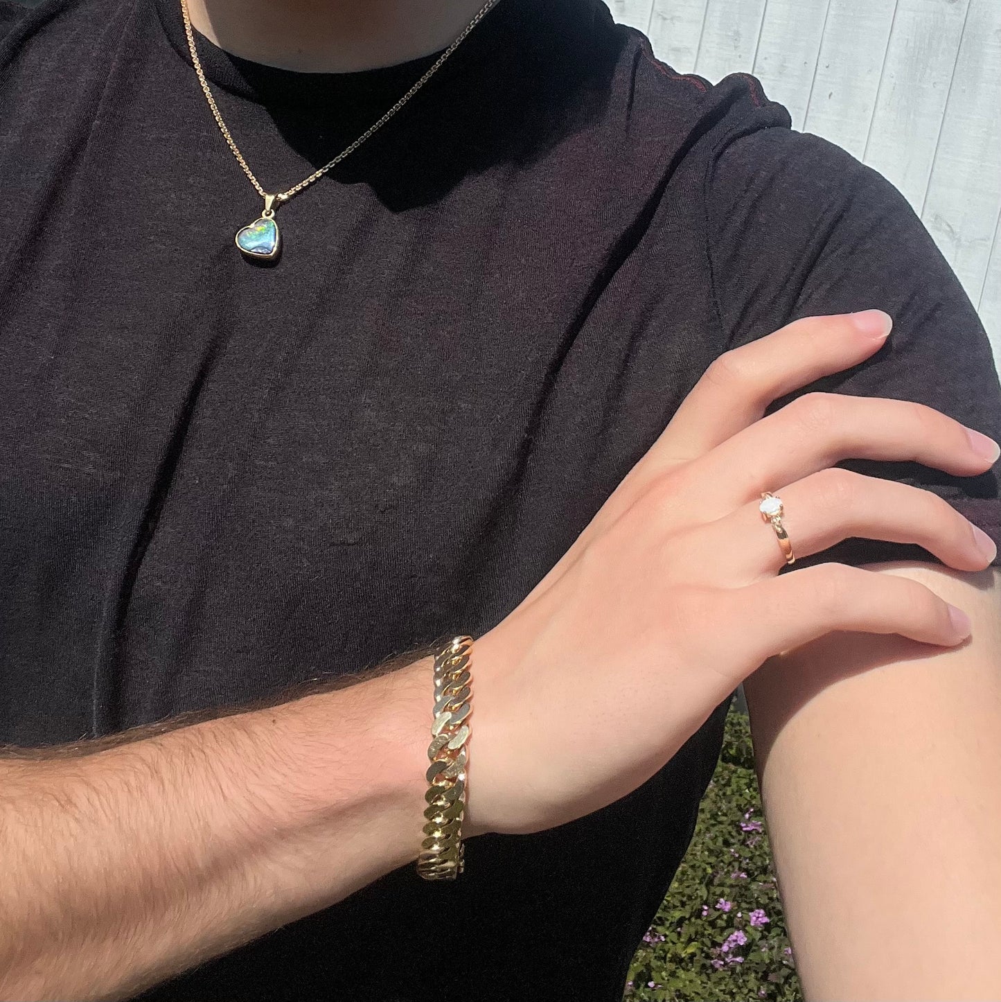 A dainty natural opal and diamond engagement ring in yellow gold.