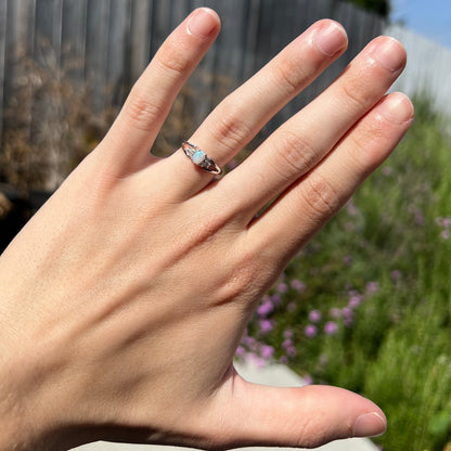 A ladies' white gold opal ring mounted with round diamond accents.