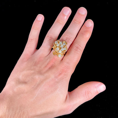 A ladies' 1950's style yellow gold and diamond cluster ring.  The ring is shaped like a leaf with 10 round diamonds set in it.