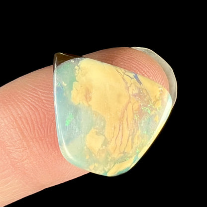 A loose, freeform shaped double-sided boulder opal stone from Quilpie, Australia.  One side is blue, the other is white.