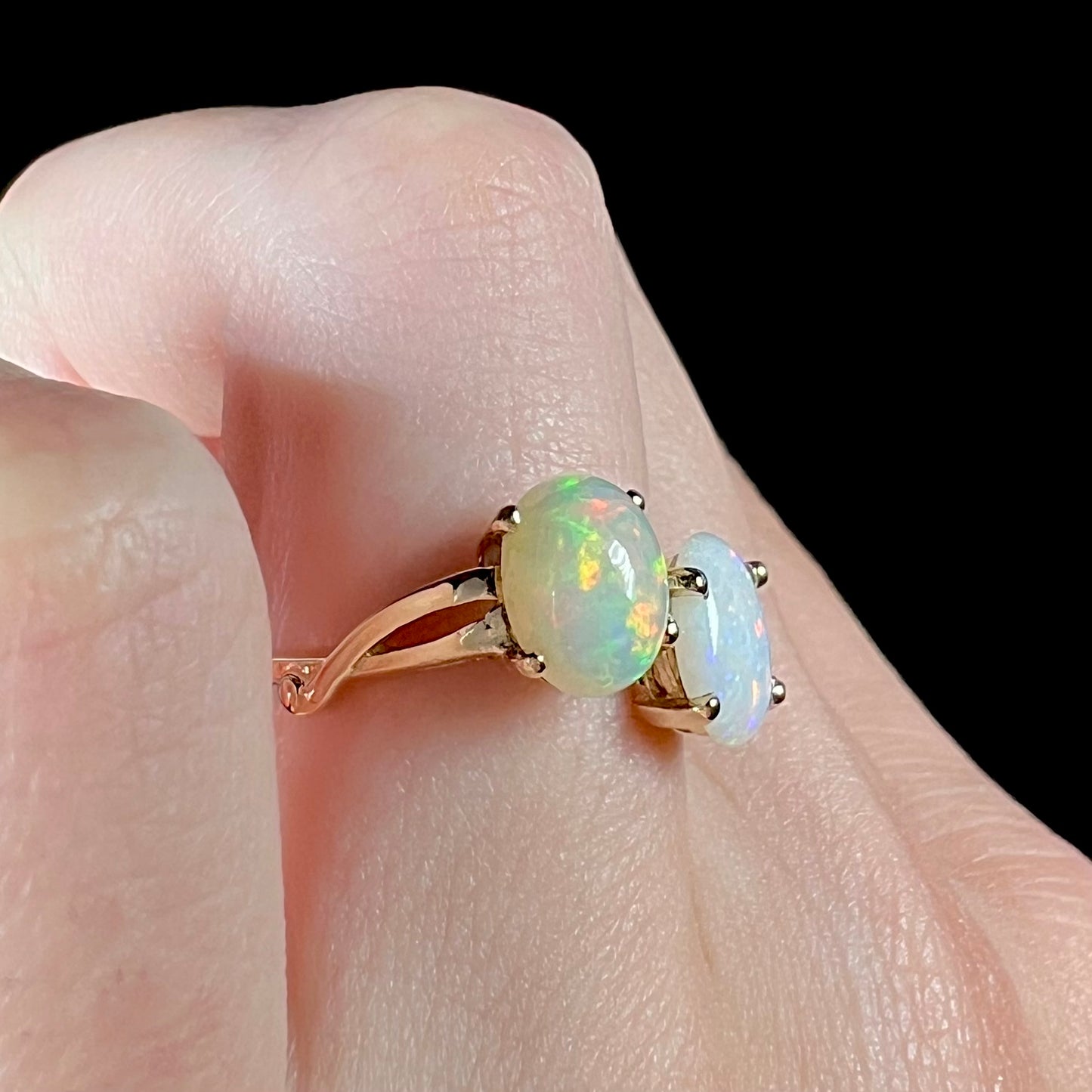 A yellow gold ring mounted with an Ethiopian fire opal and a Coober Pedy, Australian opal.