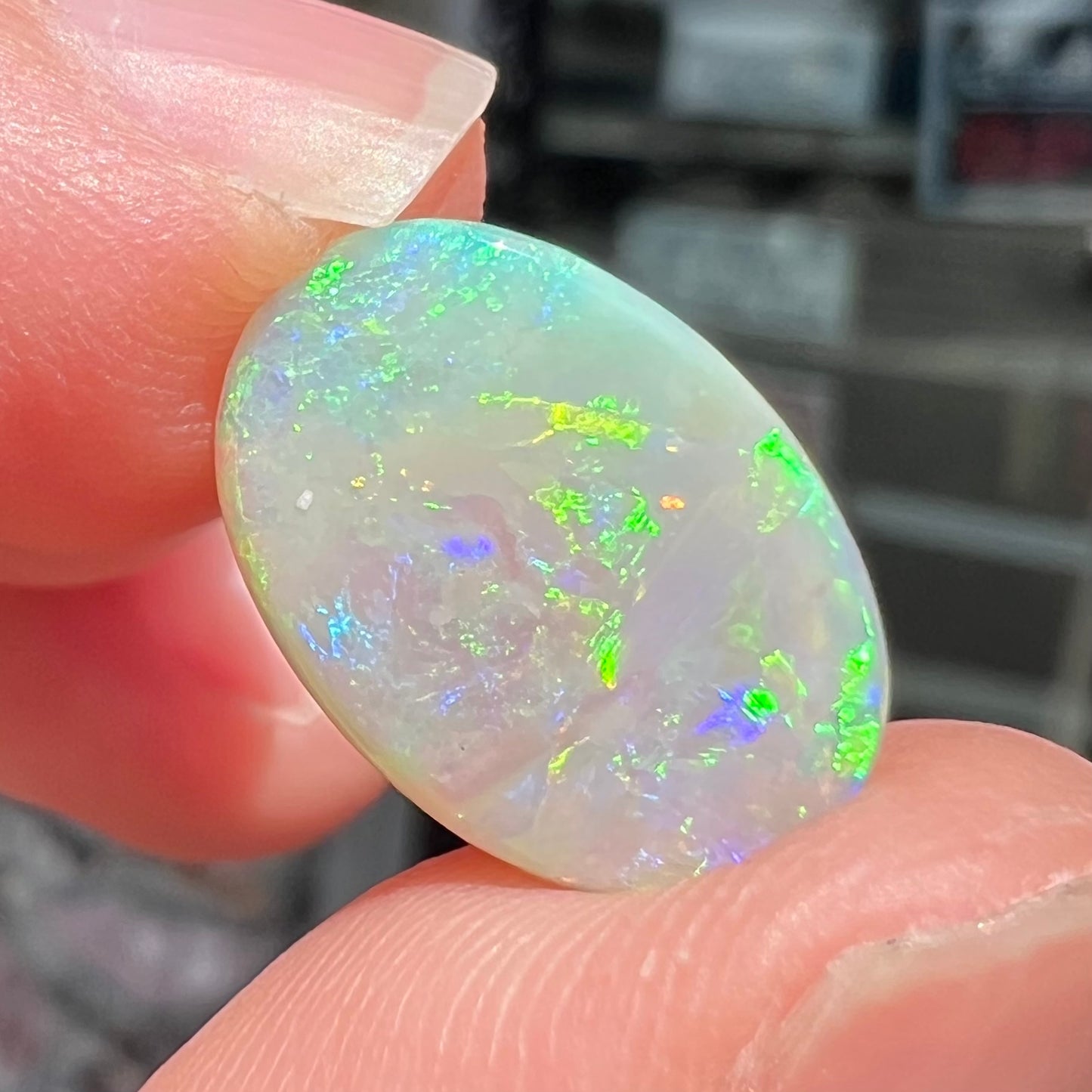 A double-sided opal stone from Coober Pedy, Australia.  The opal plays green, blue, and orange colors from the front and the back.