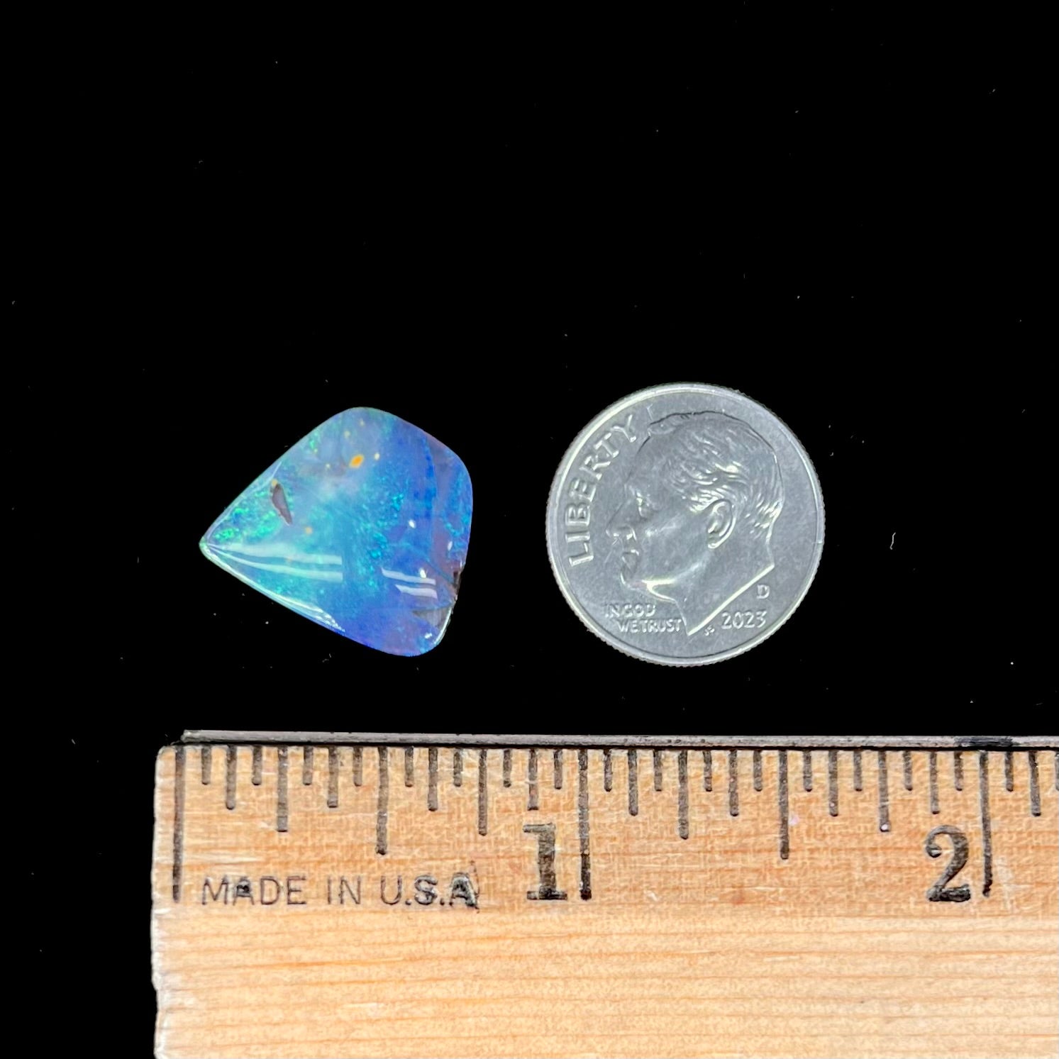 A loose, freeform shaped double-sided boulder opal stone from Quilpie, Australia.  One side is blue, the other is white.