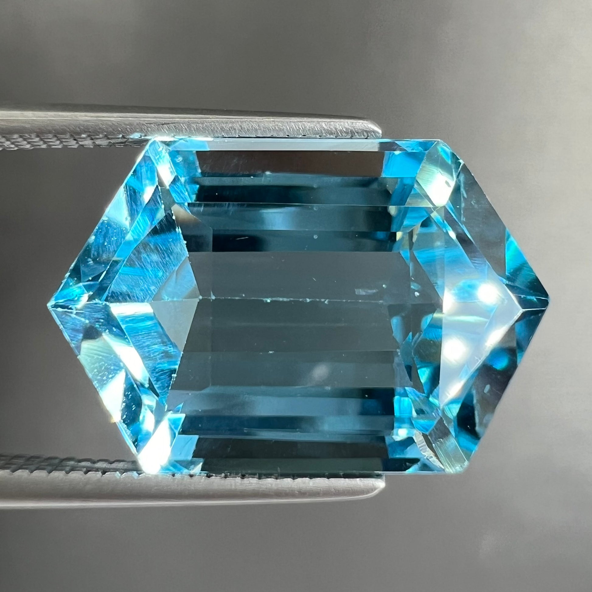 A loose, dutchess cut blue topaz gemstone.  The stone is a sky blue color.