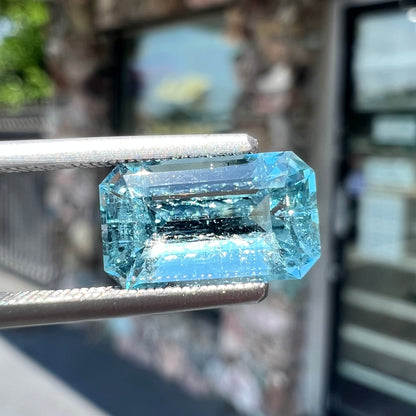 A loose, faceted emerald cut aquamarine stone.  The stone is icy blue in color, indicative of Vietnamese origin.