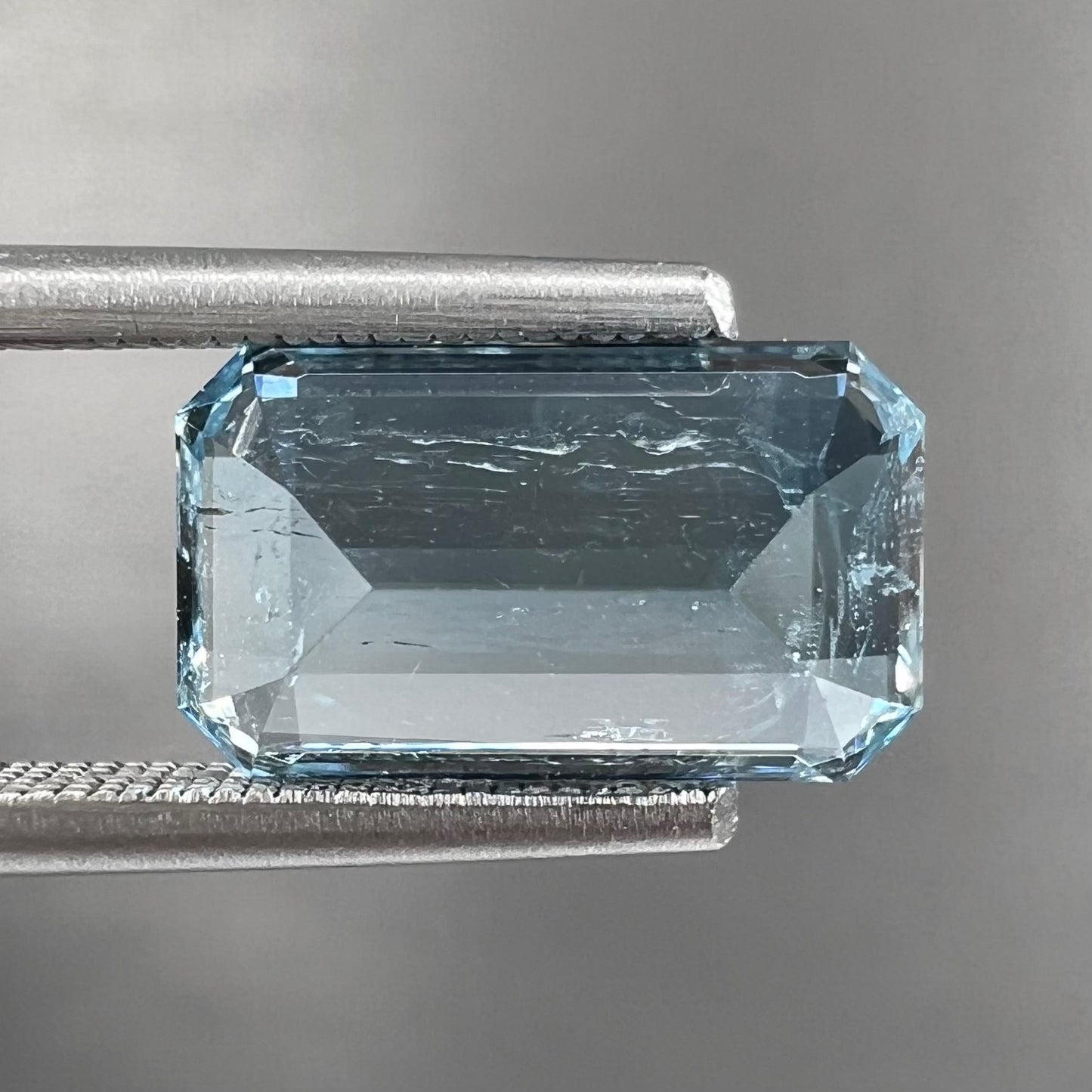 A loose, faceted emerald cut aquamarine stone.  The stone is icy blue in color, indicative of Vietnamese origin.