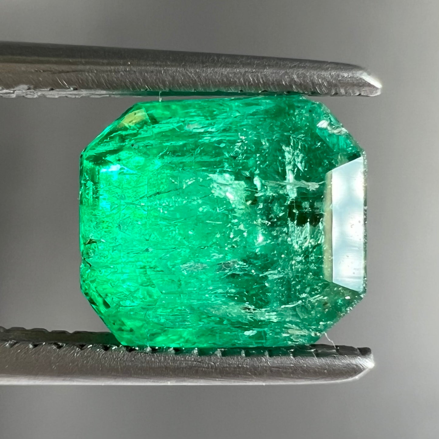 A loose, emerald cut natural emerald gemstone.