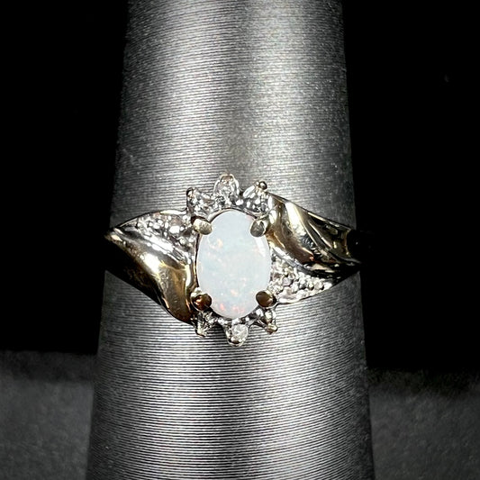 A ladies' contemporary-style gold ring mounted with a white opal and diamond accents.