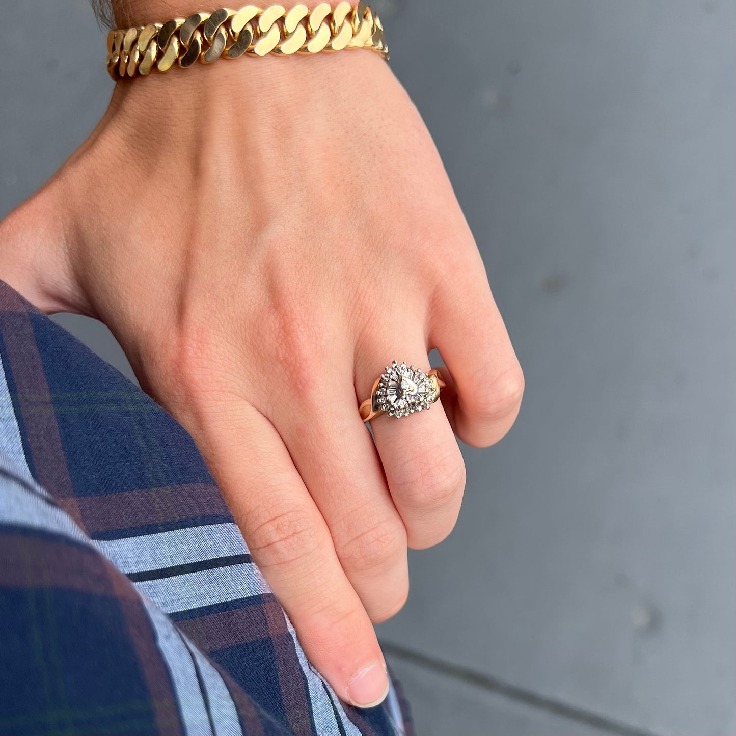 A ladies' heart shaped diamond cluster ring.  The ring is set with pear shaped, baguette cut, and round diamonds.