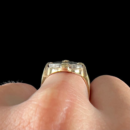 A silver Atocha 1 reale coin replica set in a yellow gold ring.