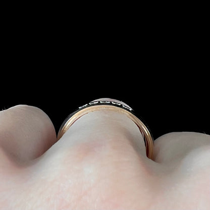 A unisex, two-tone white and yellow gold diamond wedding band.  The white gold is textured.