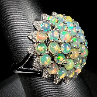 A sterling silver cluster flower ring mounted with 33 round Ethiopian fire opals.