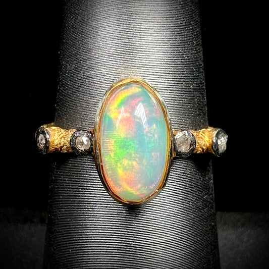 A yellow gold plated sterling silver ring mounted with an Ethiopian fire opal and rose cut diamond accents.