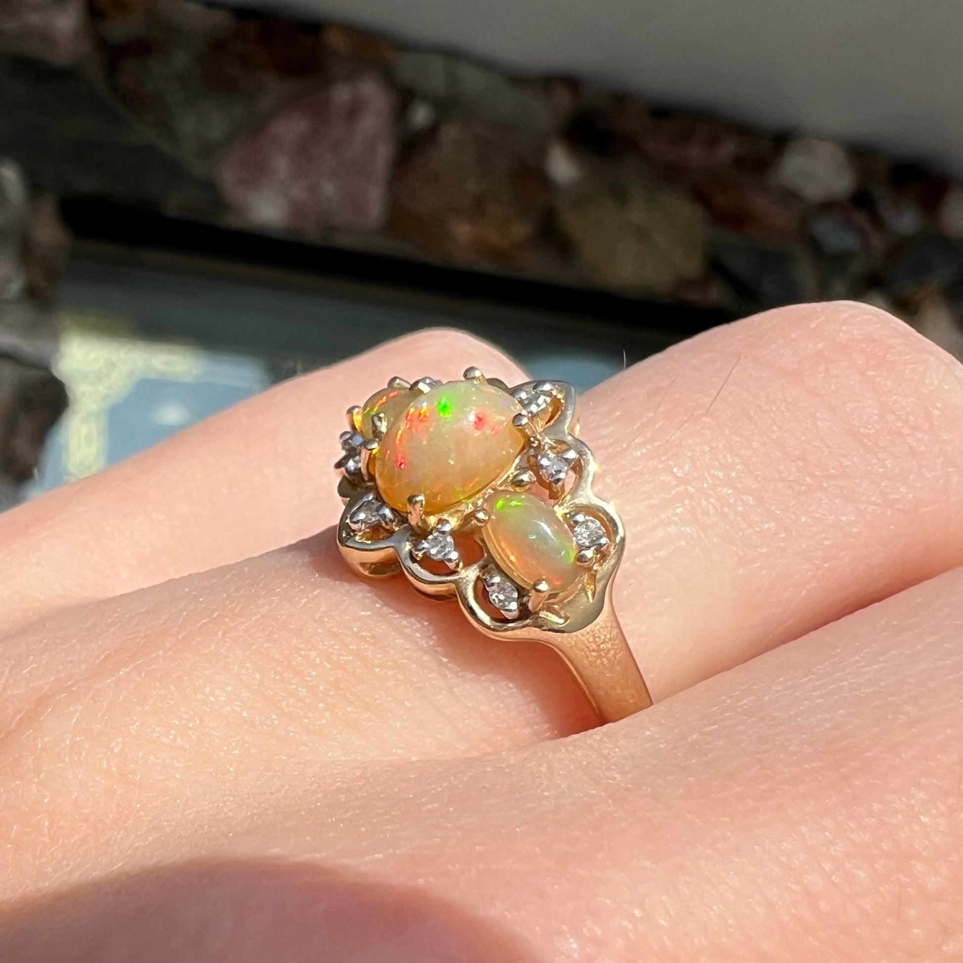 A three-stone gold ring set with Ethiopian fire opals and diamond accents.