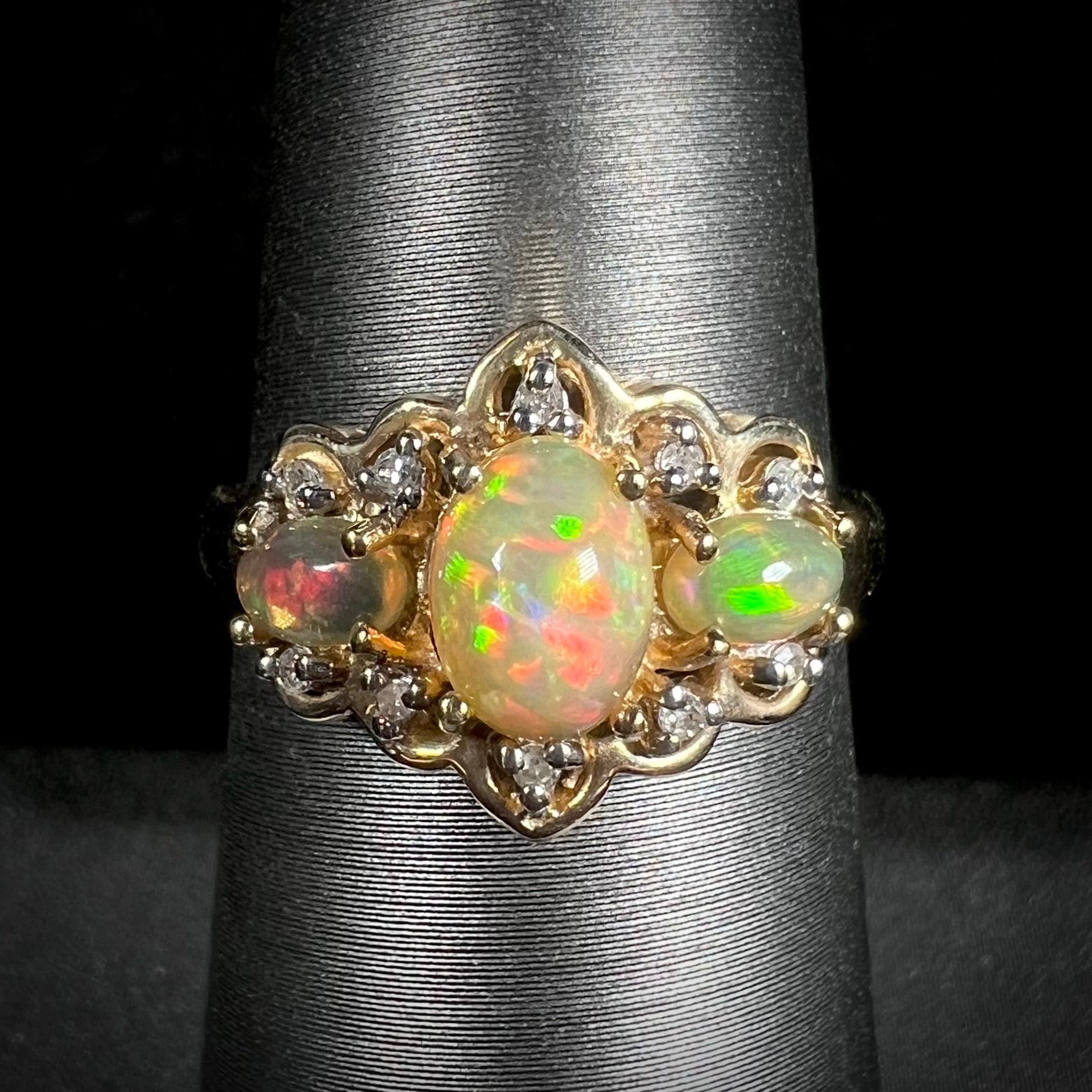 A three-stone gold ring set with Ethiopian fire opals and diamond accents.