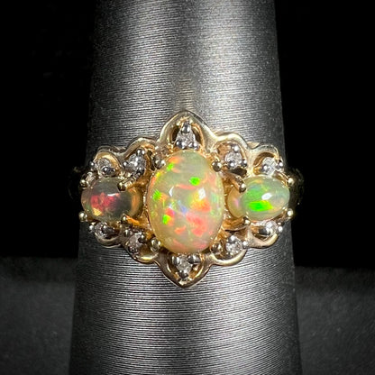 A three-stone gold ring set with Ethiopian fire opals and diamond accents.