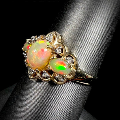 A three-stone gold ring set with Ethiopian fire opals and diamond accents.