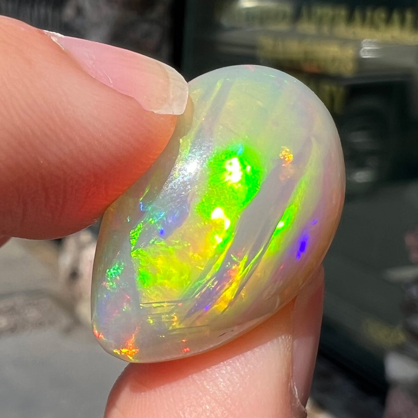 A pear shaped Ethiopian fire opal with vivid red and green play of color.