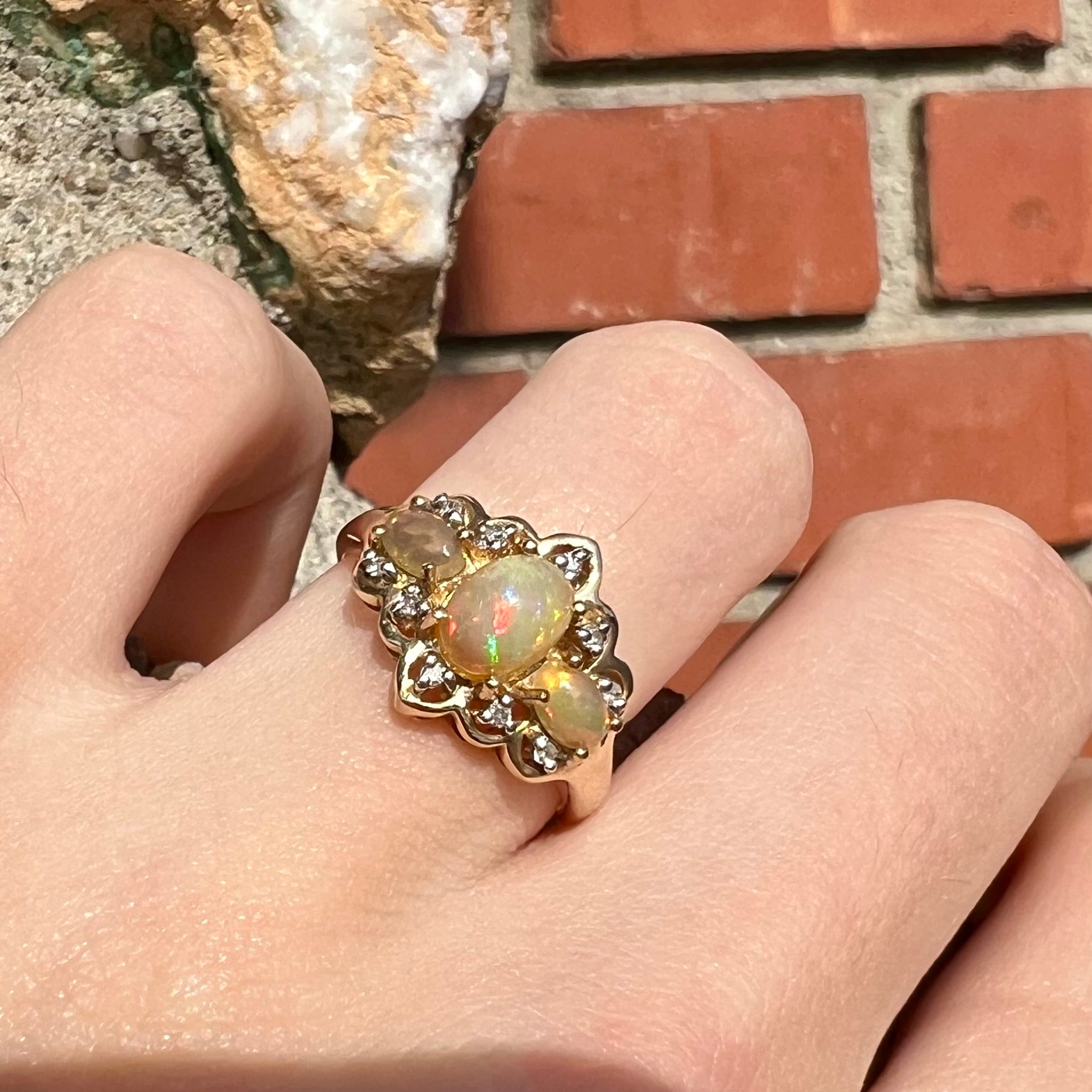 A three-stone gold ring set with Ethiopian fire opals and diamond accents.