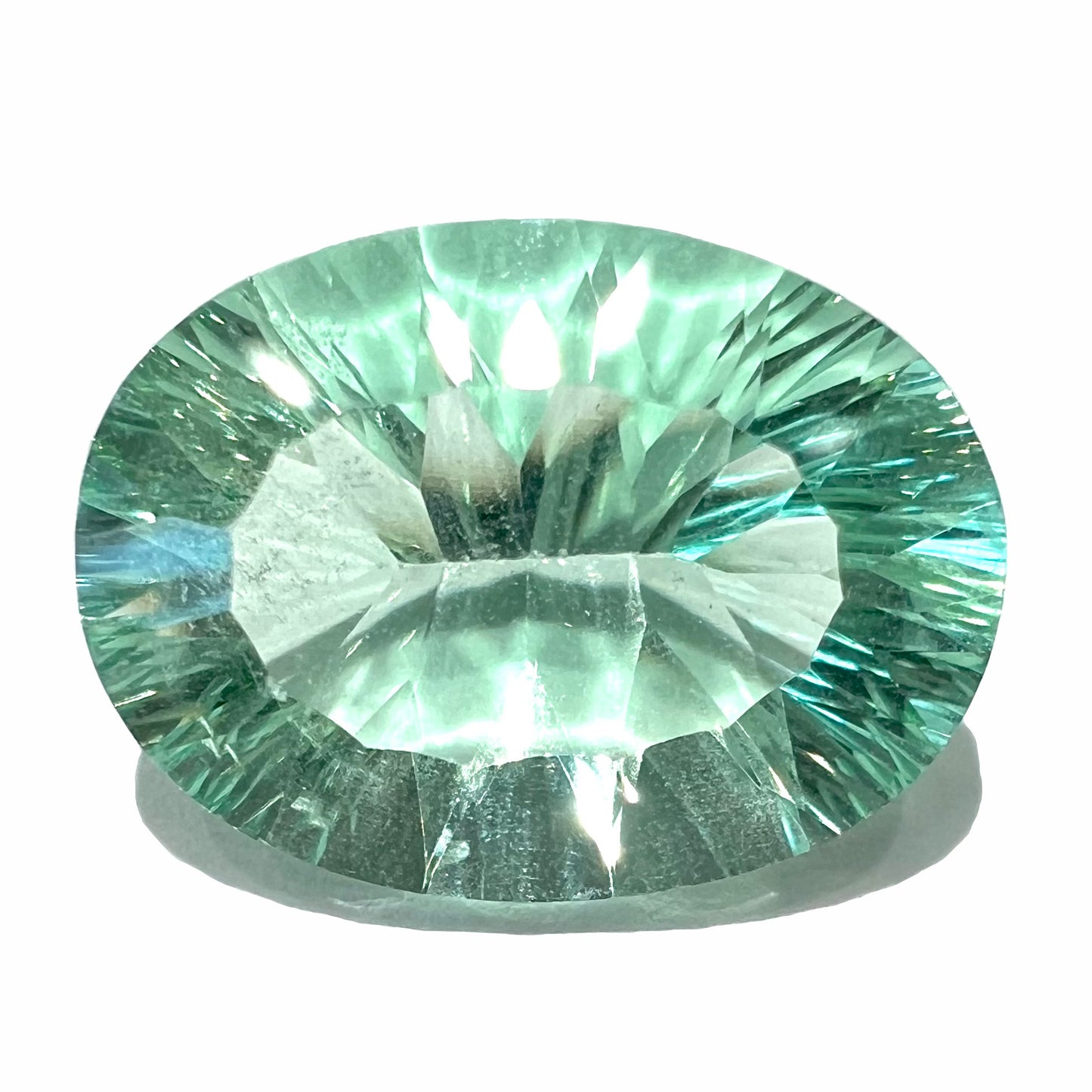 A loose, faceted oval cut mint green fluorite gemstone.  The stone weighs 13.97 carats.