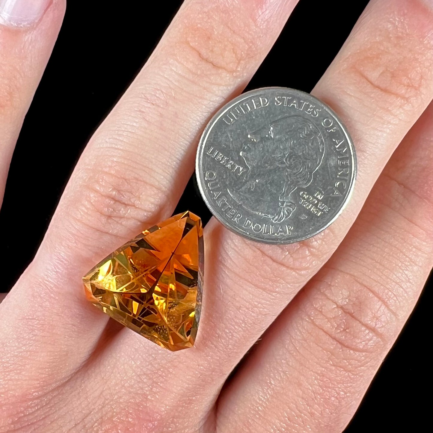 A loose, triangular fantasy cut yellow citrine stone cut by Arthur Lee Anderson.