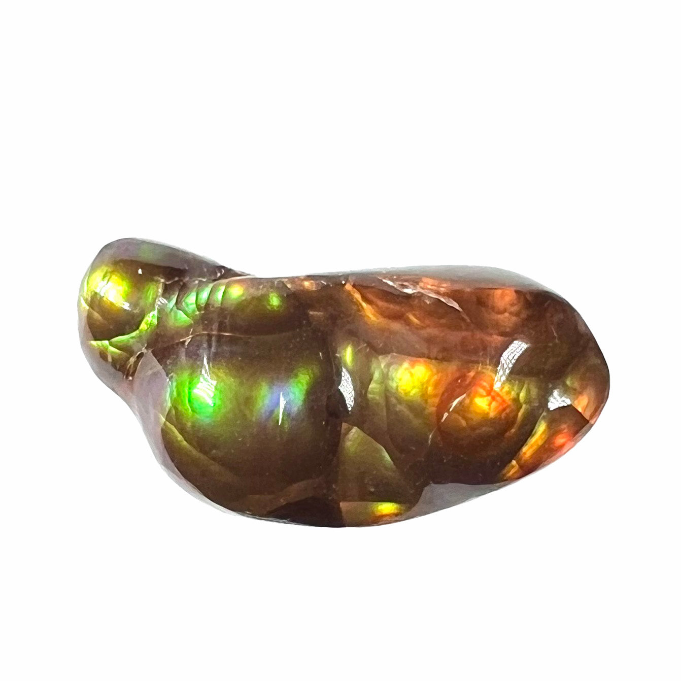 A loose, freeform shaped fire agate stone.  The fire agate has red, orange, and yellow colors on one side, and the other has green and blue colors.