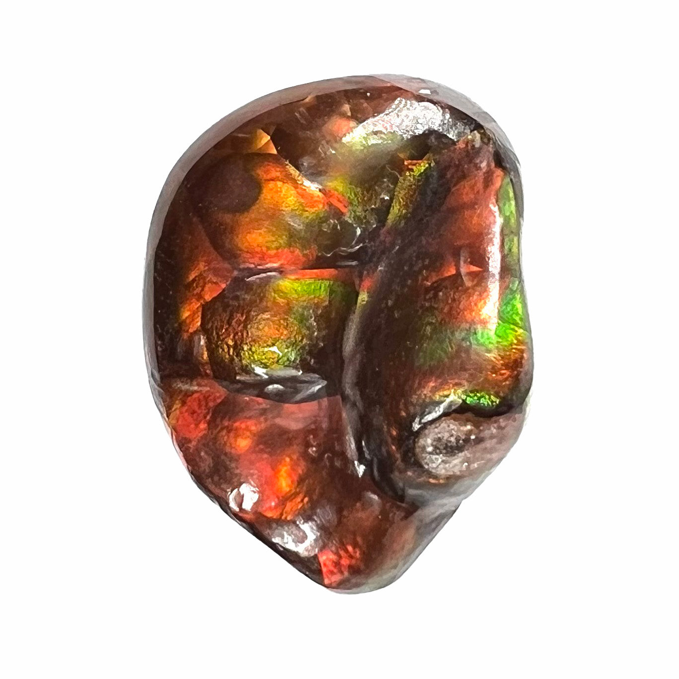 A large Mexican fire agate gemstone.  The stone is red with green iridescence and a waxy luster.