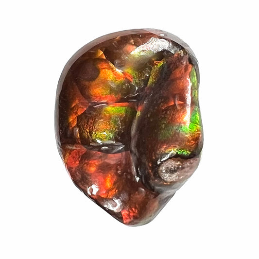 A large Mexican fire agate gemstone.  The stone is red with green iridescence and a waxy luster.